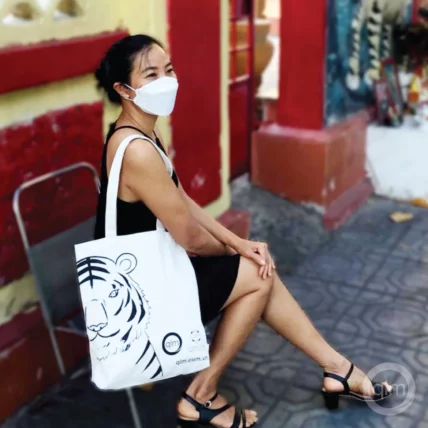 vietnamese women wearing tiger-themed totebag